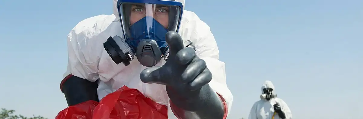 sewage clean up technician wearing protective gear handling biohazard materials in Erie, PA